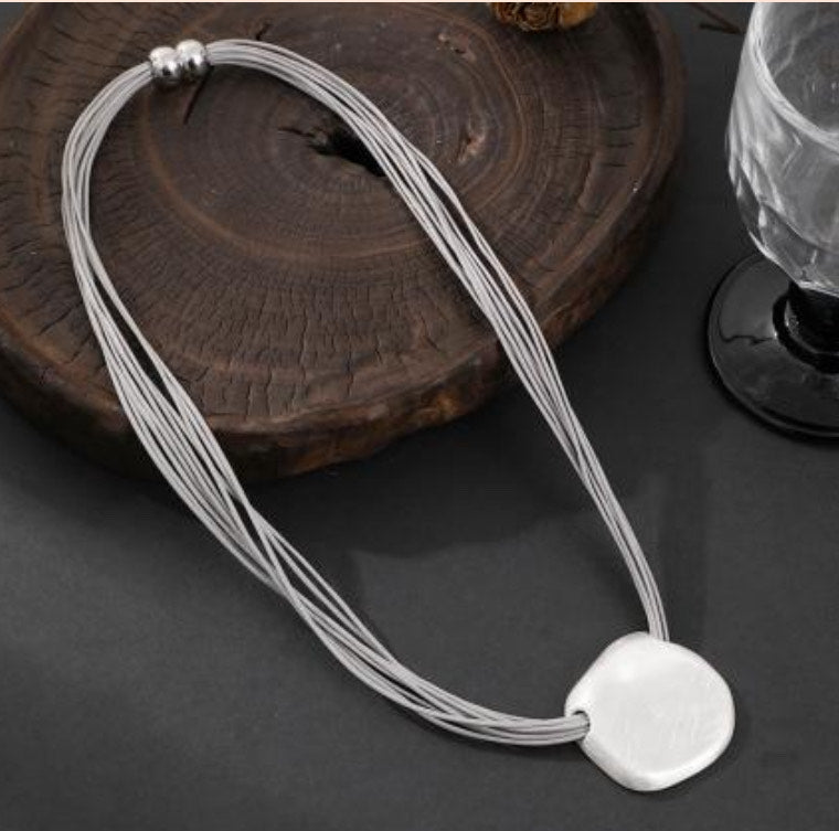 Contemporary Silver Oval Pendant on Layered Grey Cord