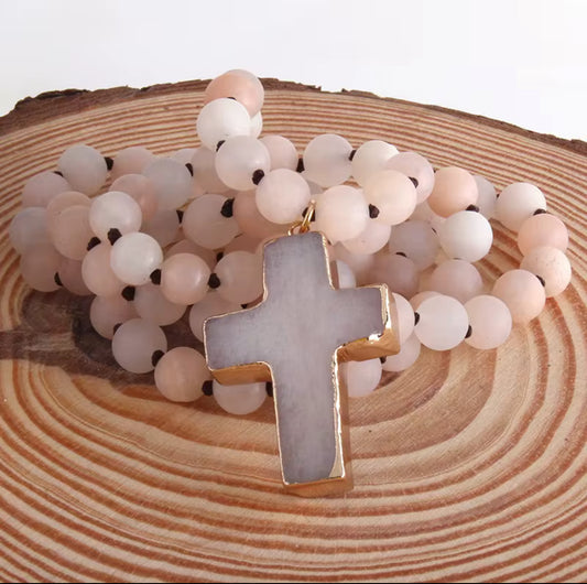 Necklace Featuring a Rose Quartz Cross With Gold Bevel